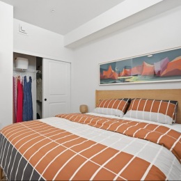 bedroom with bed and closet with hanging clothes