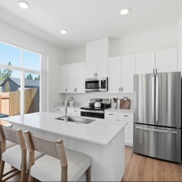 kitchen is large island and stainless steel appliances
