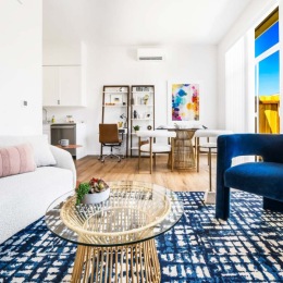living room with furniture and view of a dining room