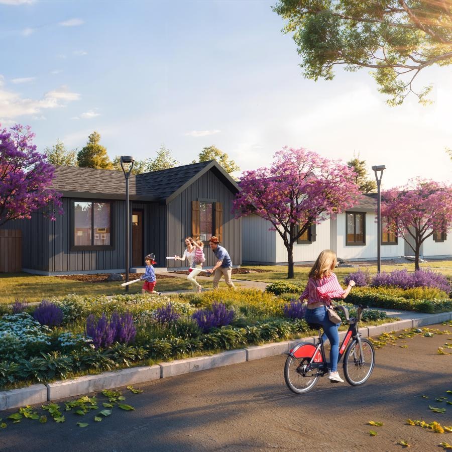 a girl riding a bicycle on a sidewalk in front of a house
